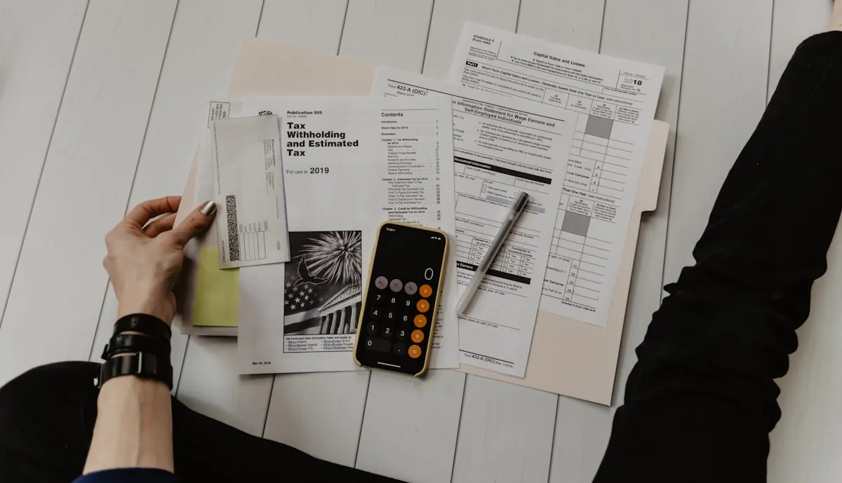 Calculator and financial papers arranged on a desk