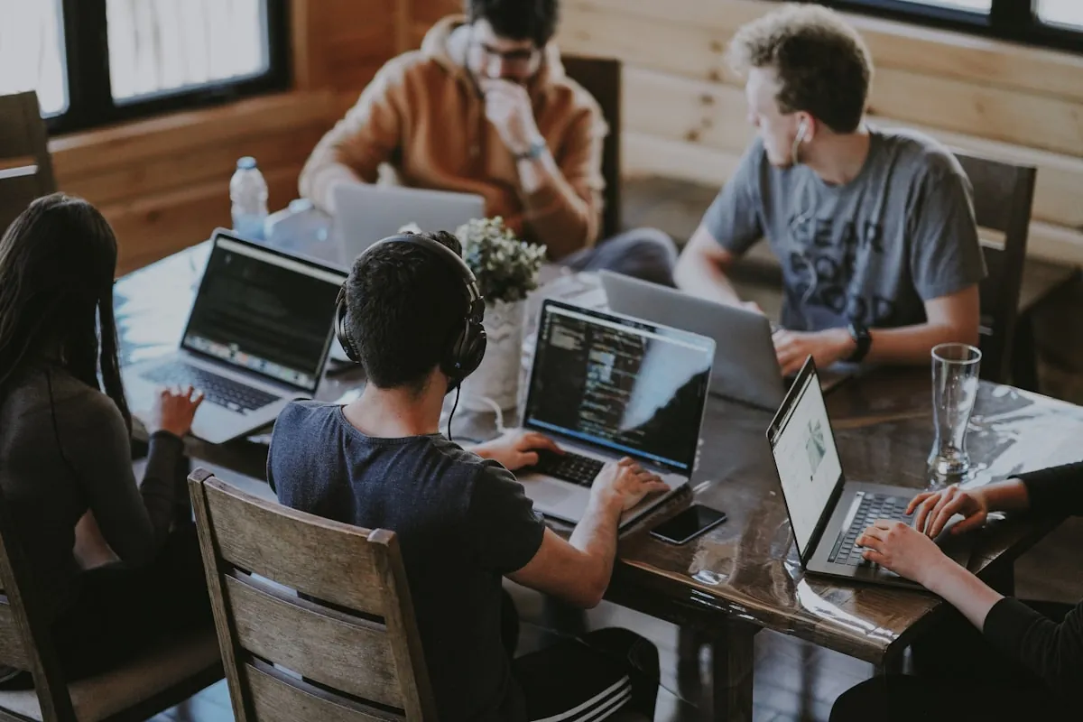 Coworkers working together around a laptop